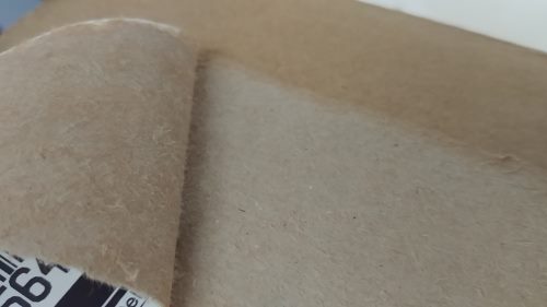 Peeling a label off cardboard. As the adhesive is stronger that the substrate, the substrate has failed instead of the adhesive.