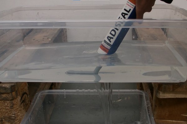 Demonstration of waterproof metal sealant sealing a leak underwater.