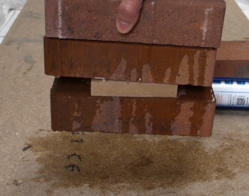 Grab demonstration of wet sealant on wet bricks. Ideal for use as an underwater glue.